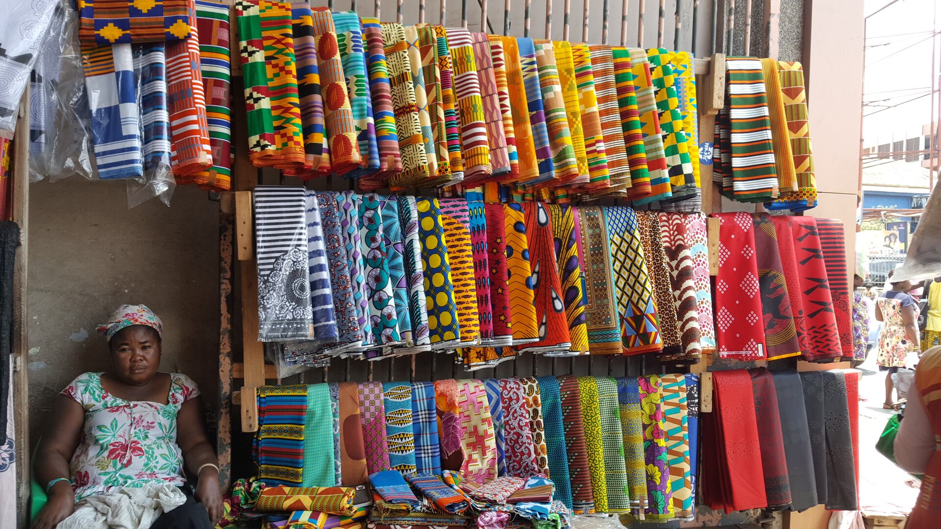 Traders and goods at a busy Accra market.