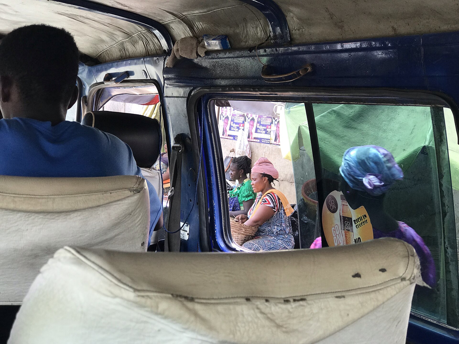 A minibus (tro-tro) in Accra street traffic.